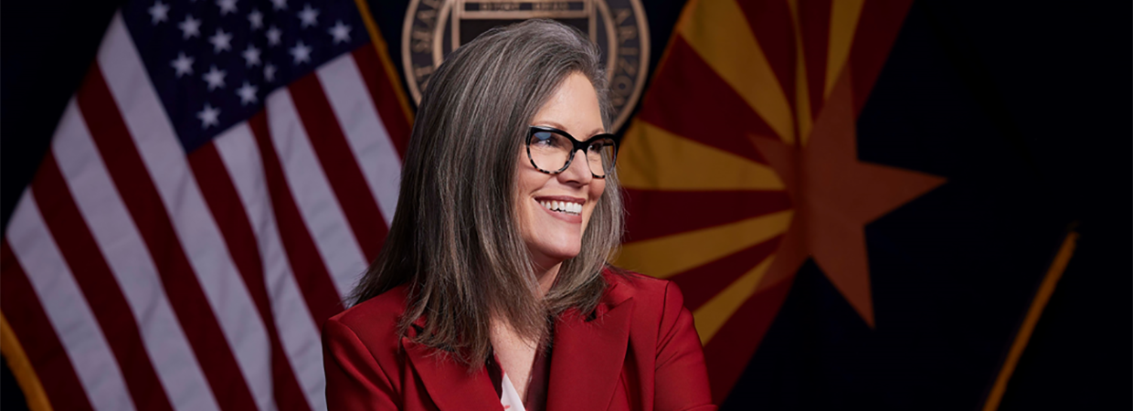 Image of Arizona Governor Katie Hobbs in front of American and Arizona Flag
